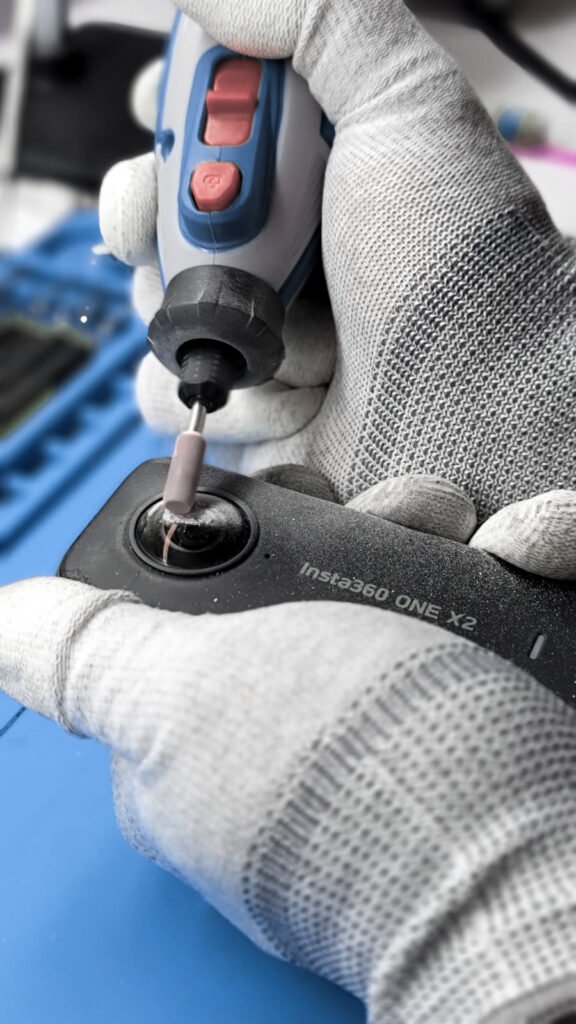 The picture shows two hands holding and reparing the lens of an Insta360 action camera on the website of 'The House Technology', specialists in action cameras and accessories for GoPro and Insta360.