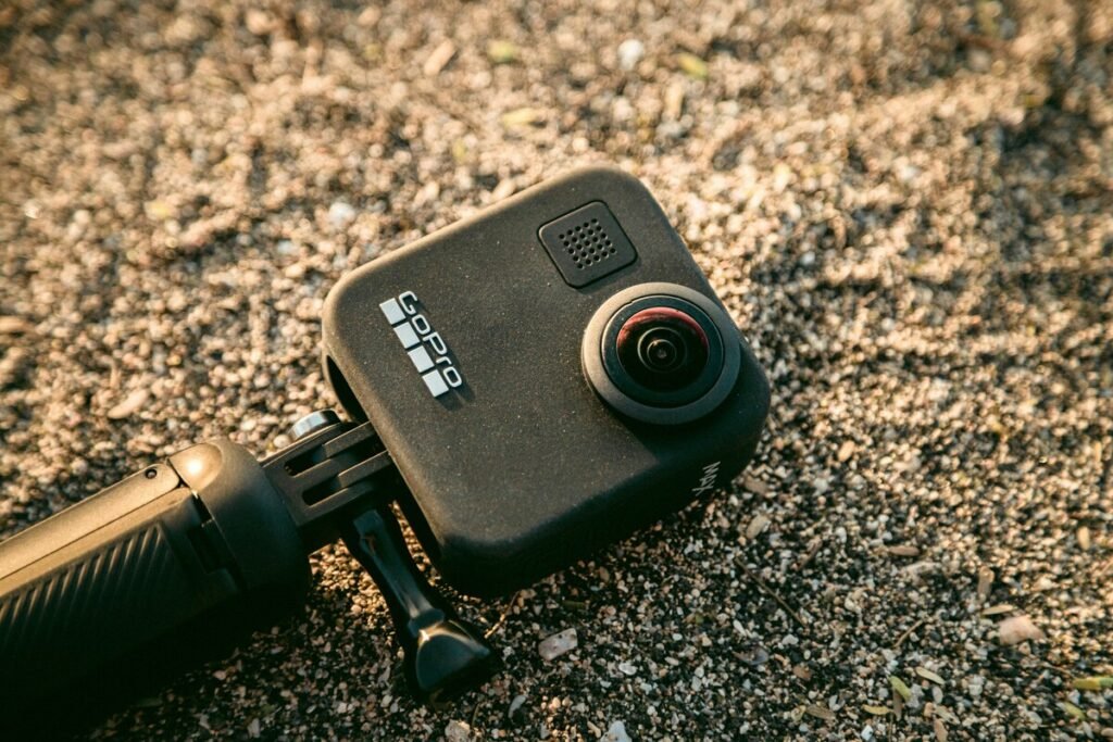 Picture of a GoPro action camera laying on sandy ground on the website of 'The House Technology', specialists in action cameras and accessories for GoPro and Insta360.