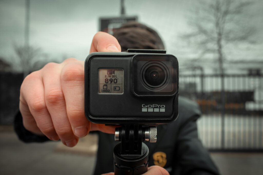 The picture shows a GoPro action camera in the foreground covering the face of the man behind the camera on the website of 'The House Technology', specialists in action cameras and accessories for GoPro and Insta360.