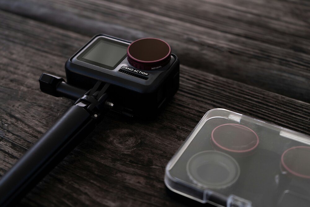 The picture shows an action camera with lens covers on a wooden background on the website of 'The House Technology', specialists in action cameras and accessories for GoPro and Insta360.